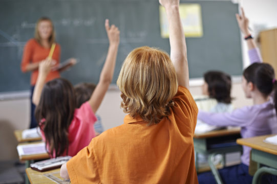 Kids-raising-hands-in-class